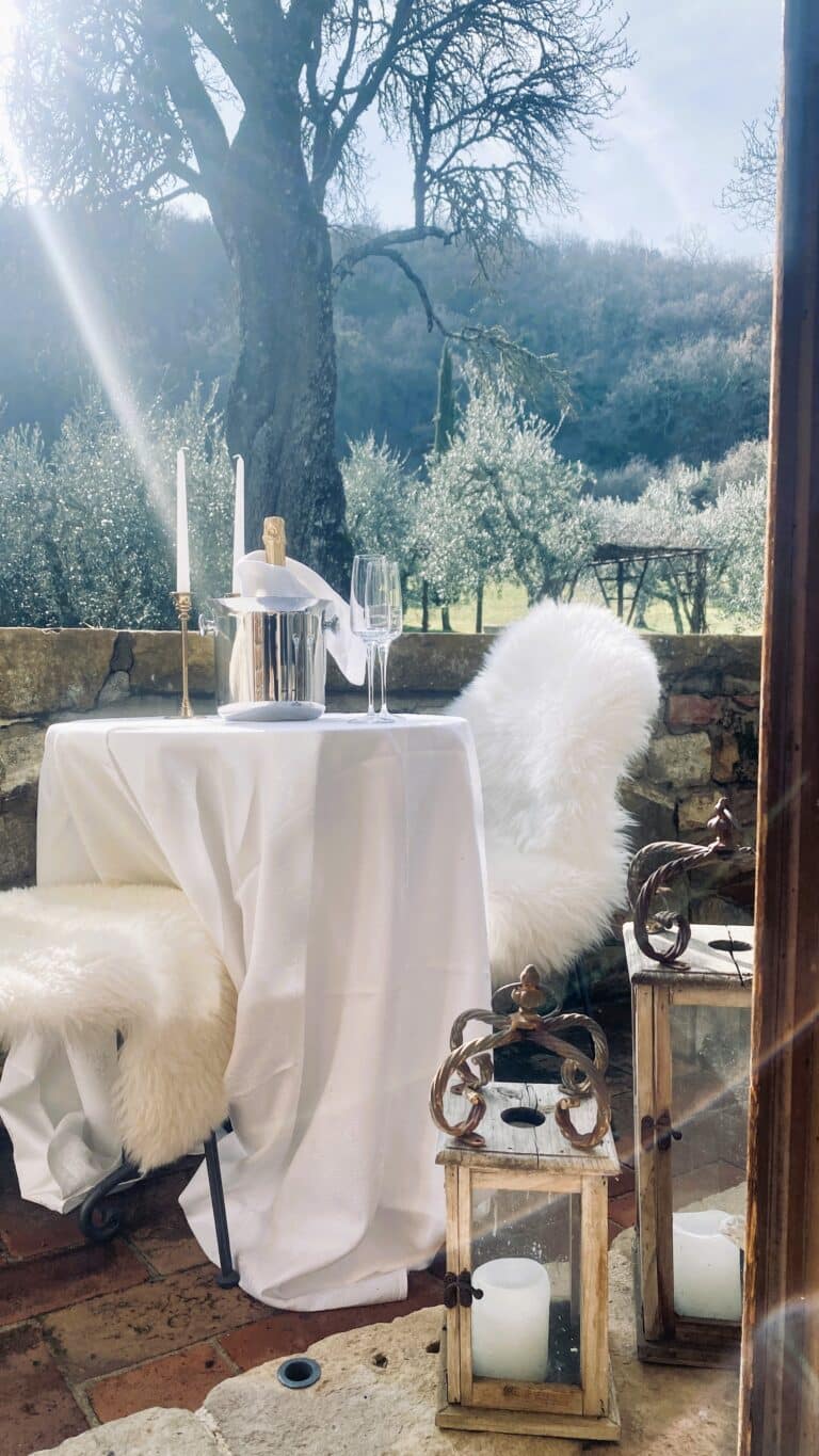 Romantic marriage proposal on the terrace with Prosecco and views of Val d'Orcia.